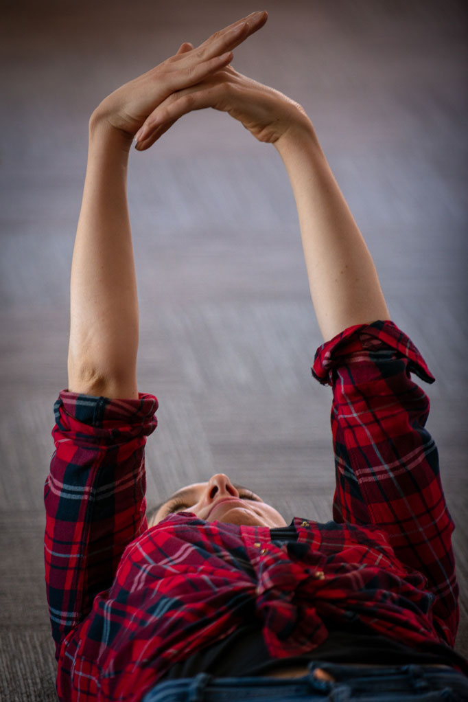 Participant laying down on the floor and rising hands